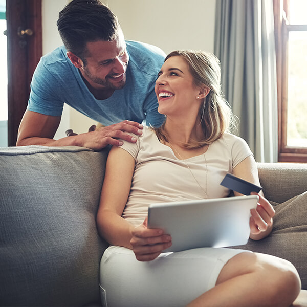 Couple with debit card and laptop