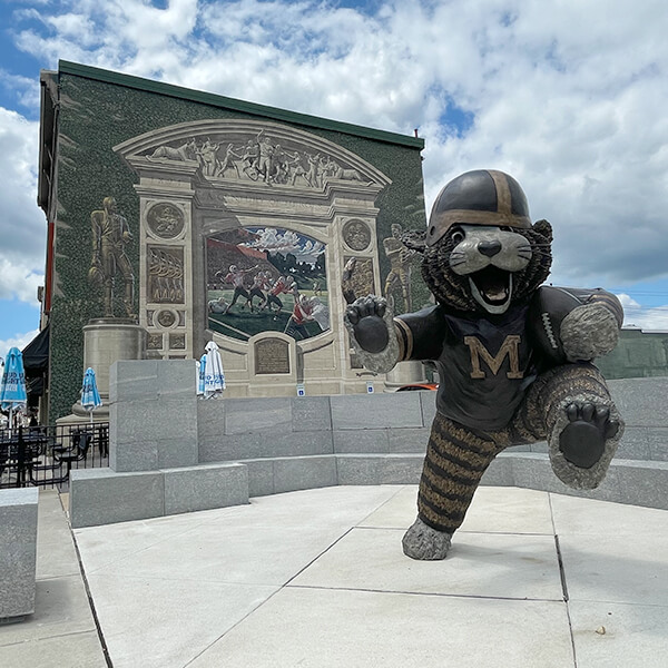 Statue of the Massillon Tiger and football wall mural in Massillon Ohio