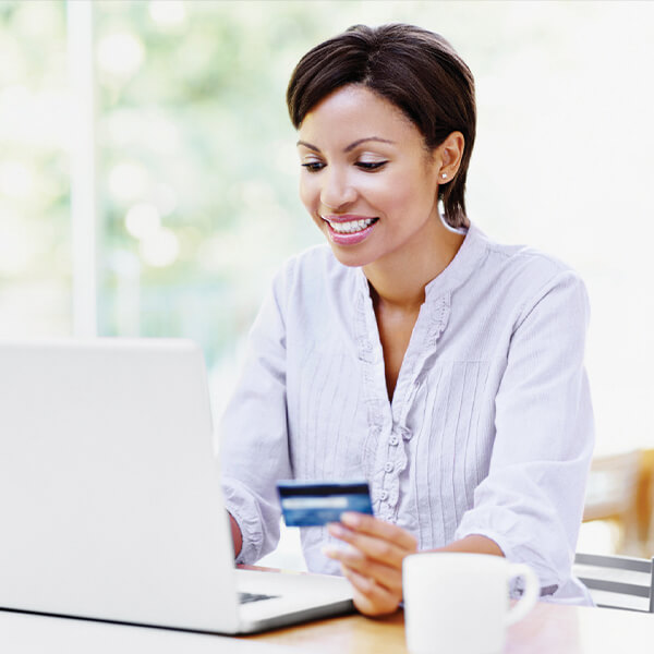 Woman with credit card and laptop